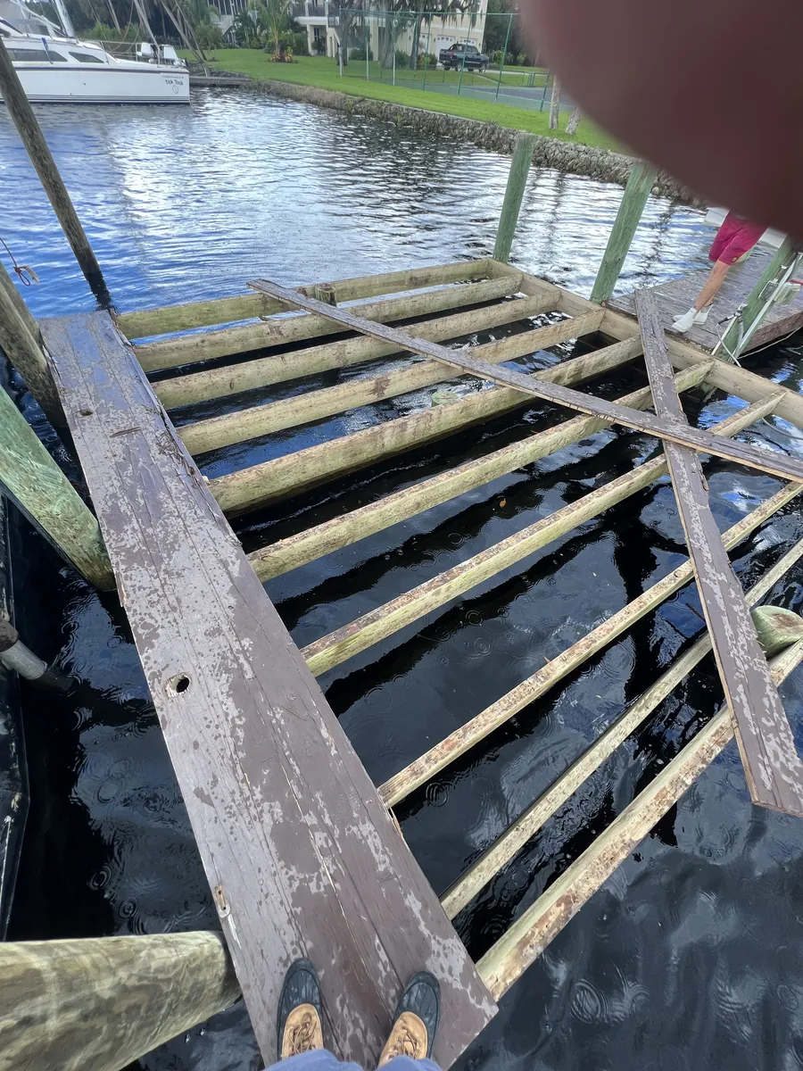 Exposed timber dock joists and boards over water