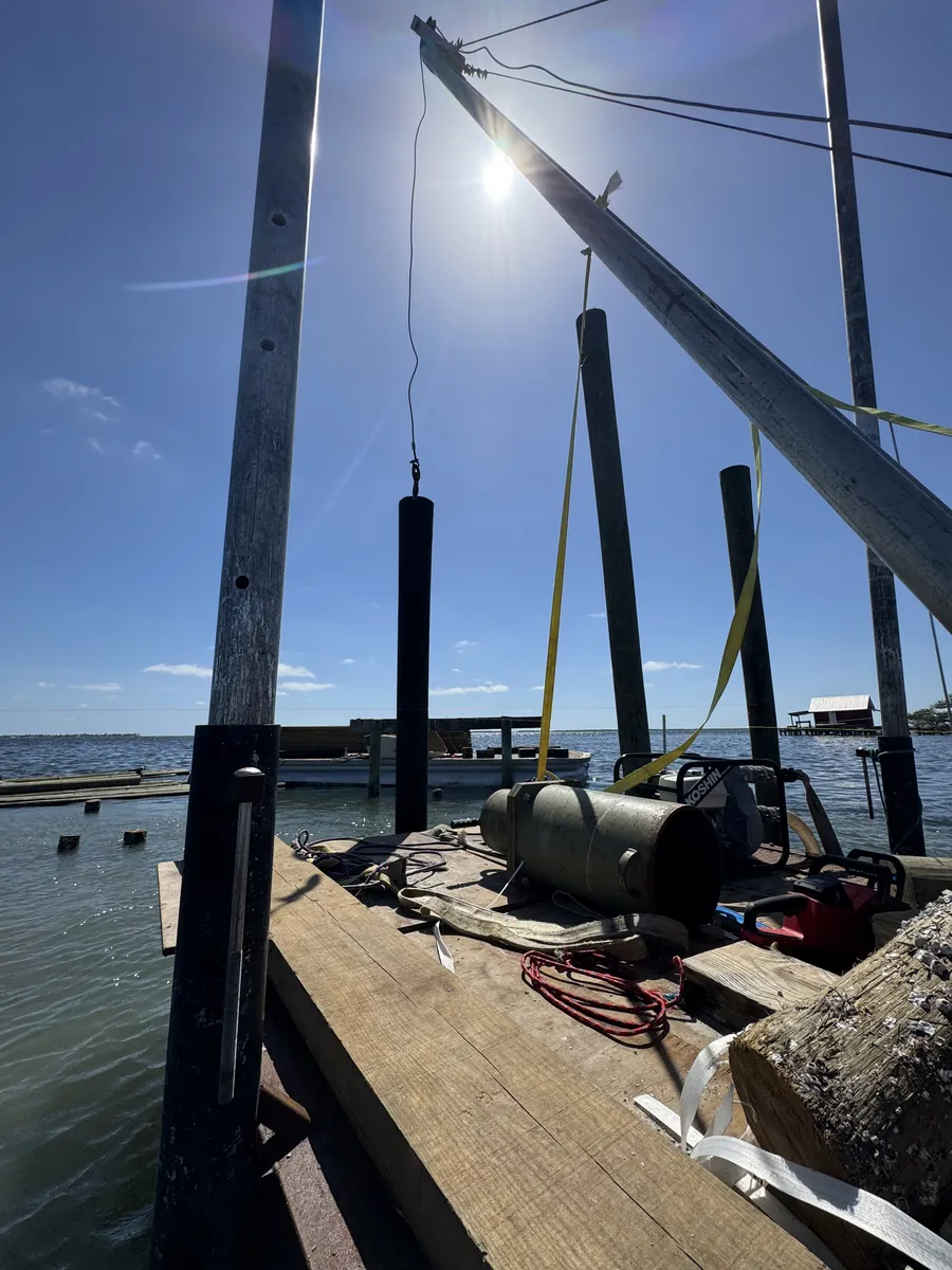 Crane and pile driving equipment aboard a marine work barge